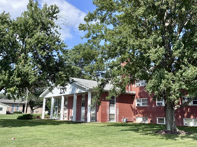 The Eta Mu chapter house at 2103 framed by trees and lawn