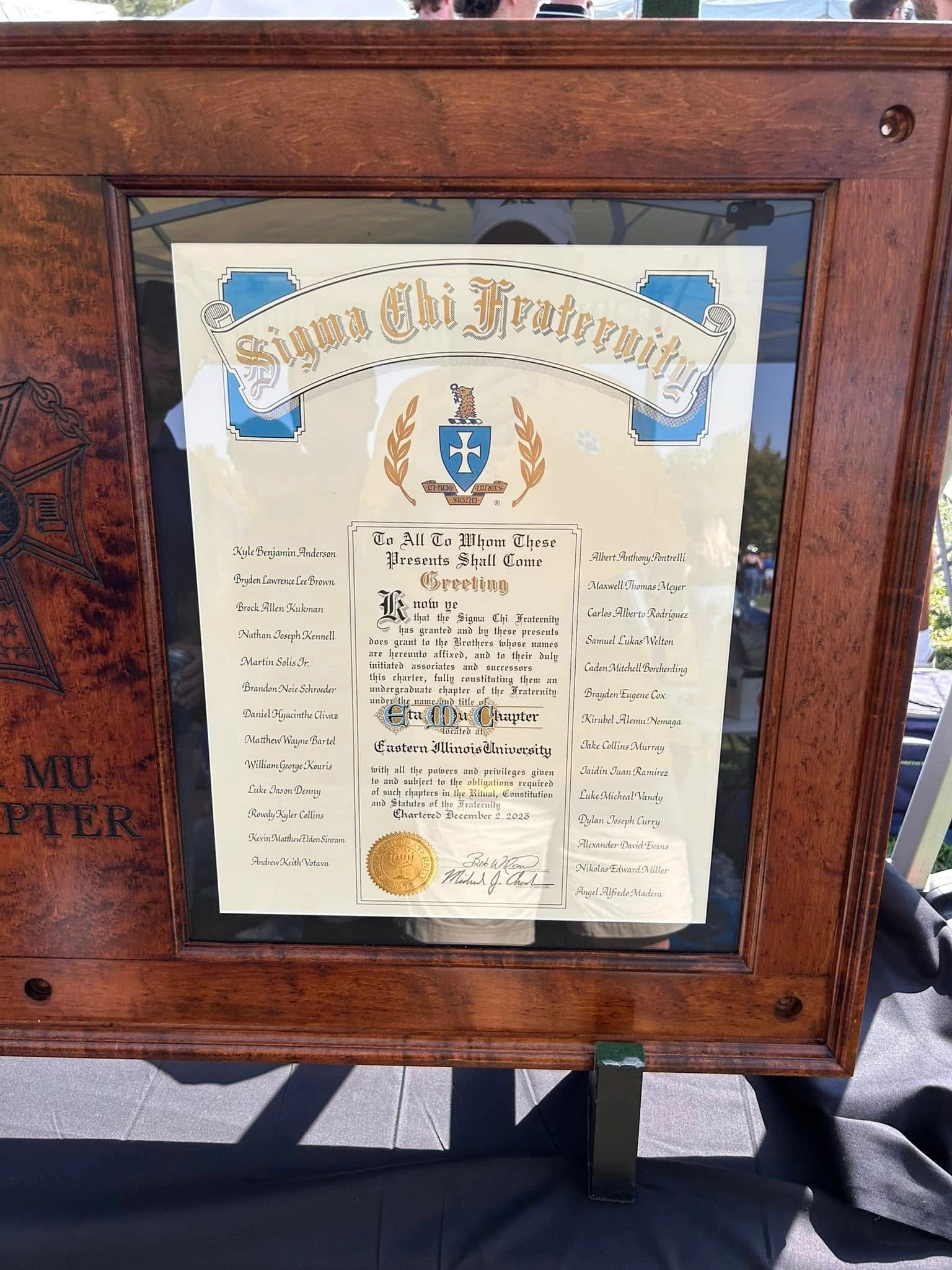 Framed Eta Mu Sigma Chi charter, photographed from another angle